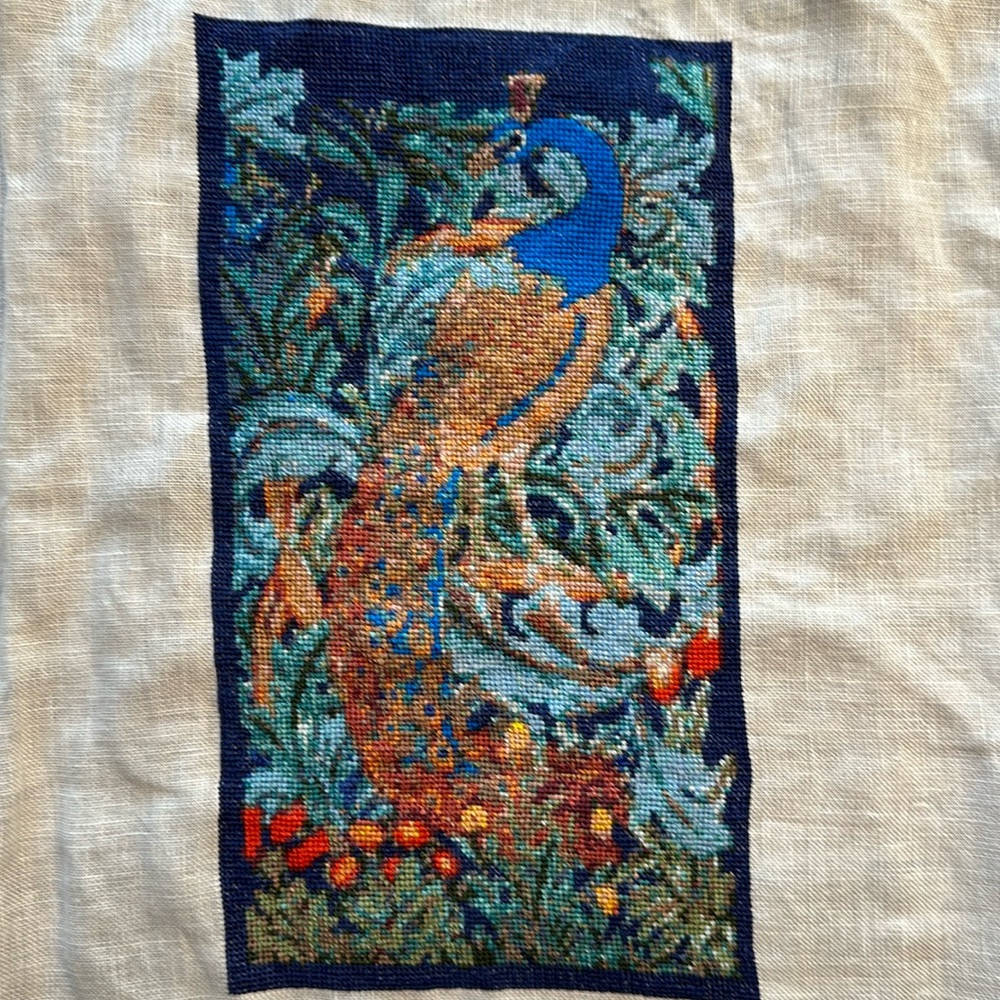 Unframed cross stitch piece on linen